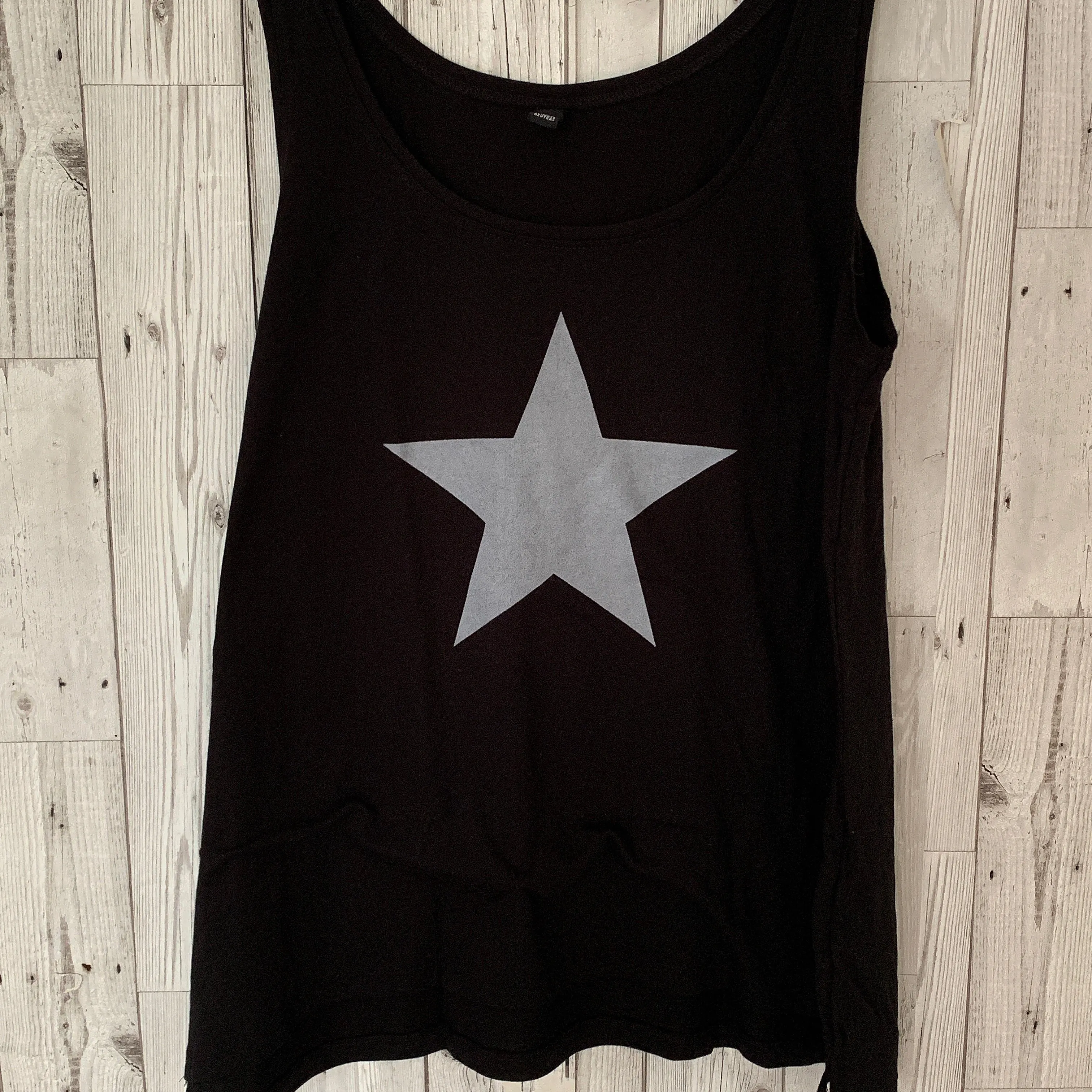 Silvery grey star on black vest top